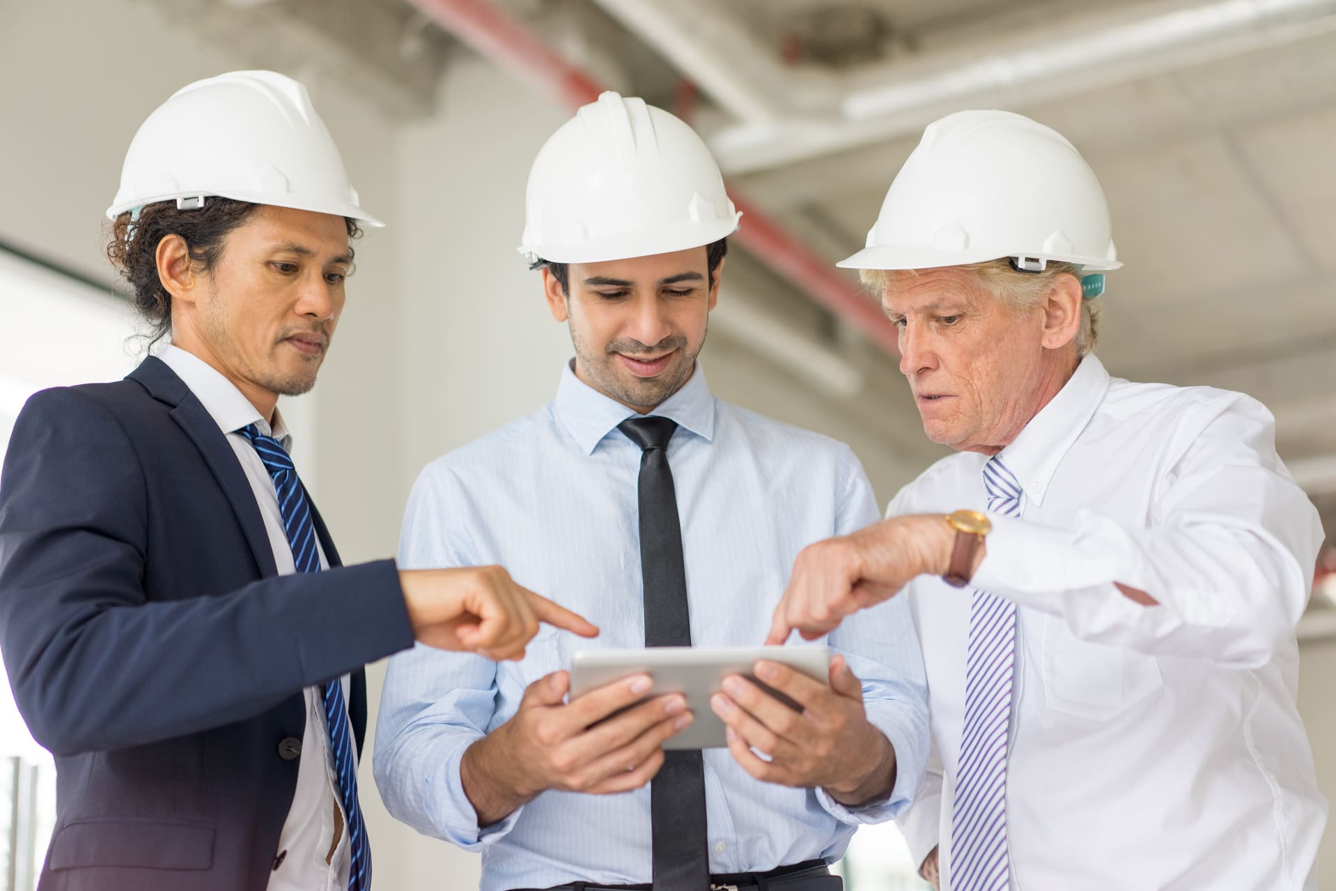 Architects reviewing a construction project on a tablet