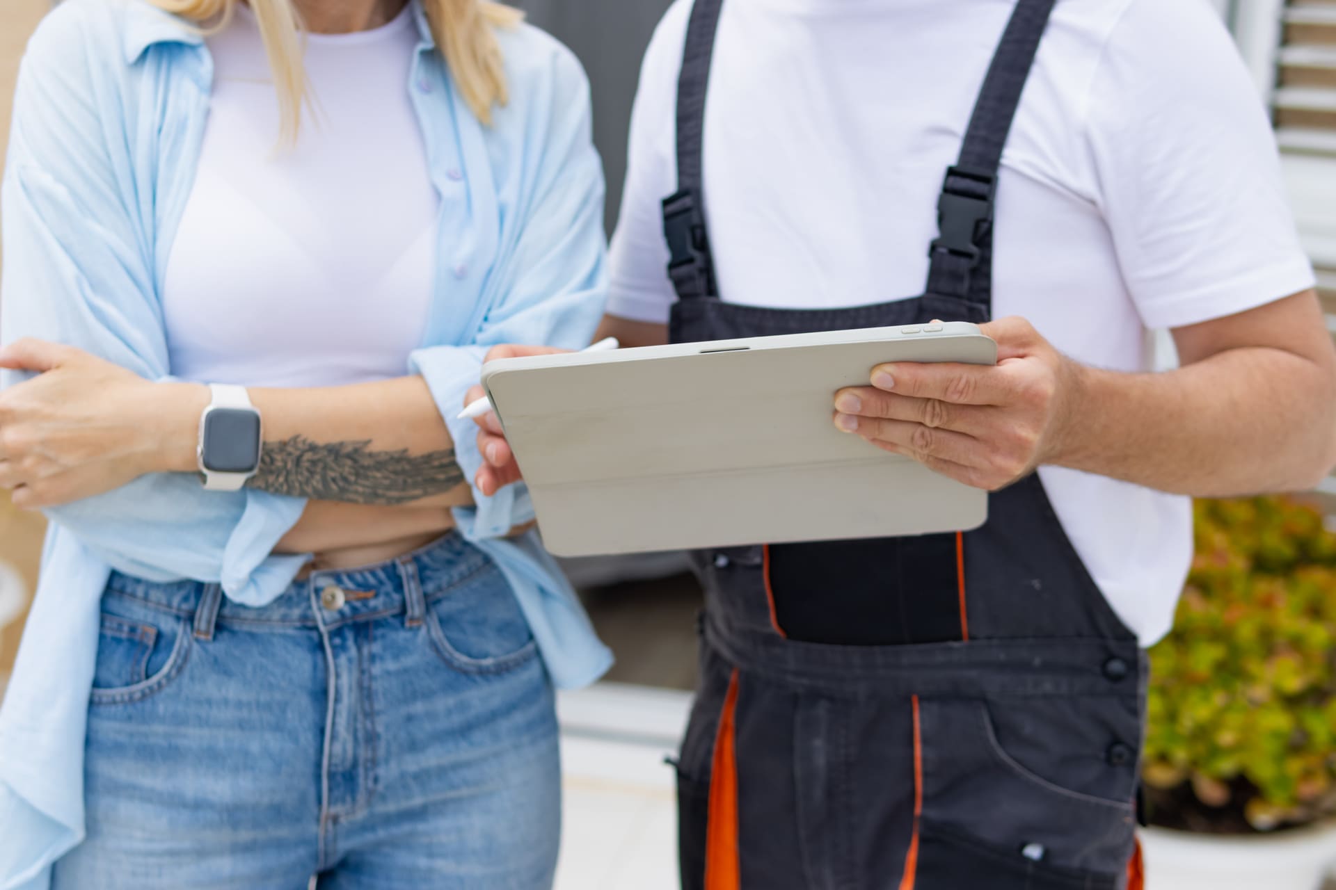 Contractor and homeowner reviewing a service estimate on a tablet