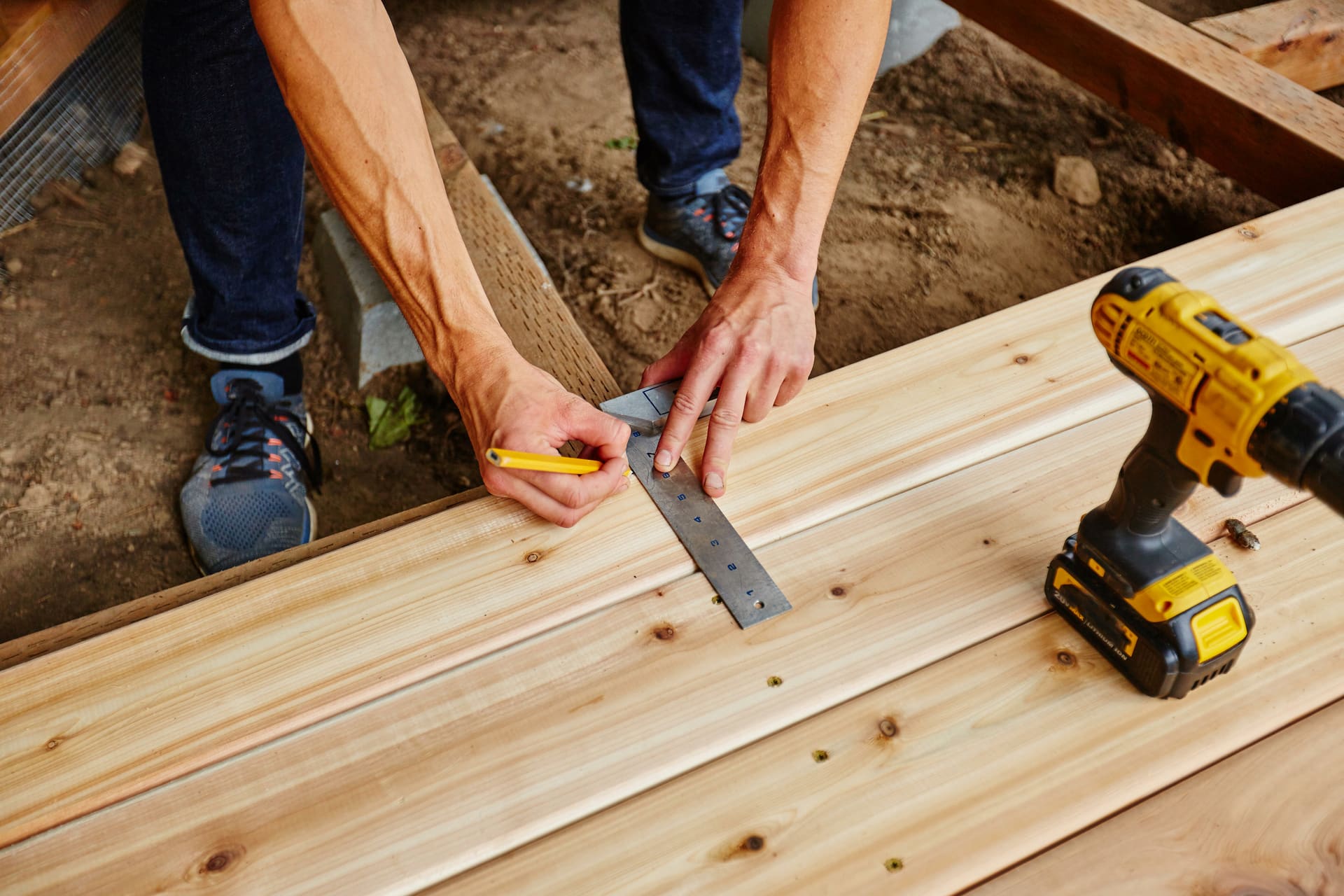 Carpenter measuring boards for a residential deck