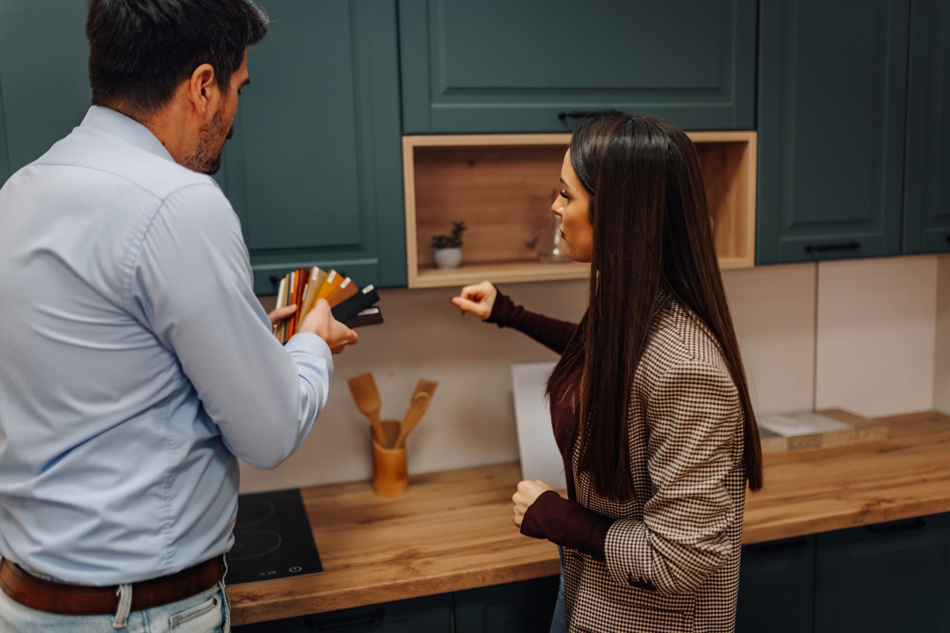 Contractor and homeowner choosing materials for a kitchen renovation