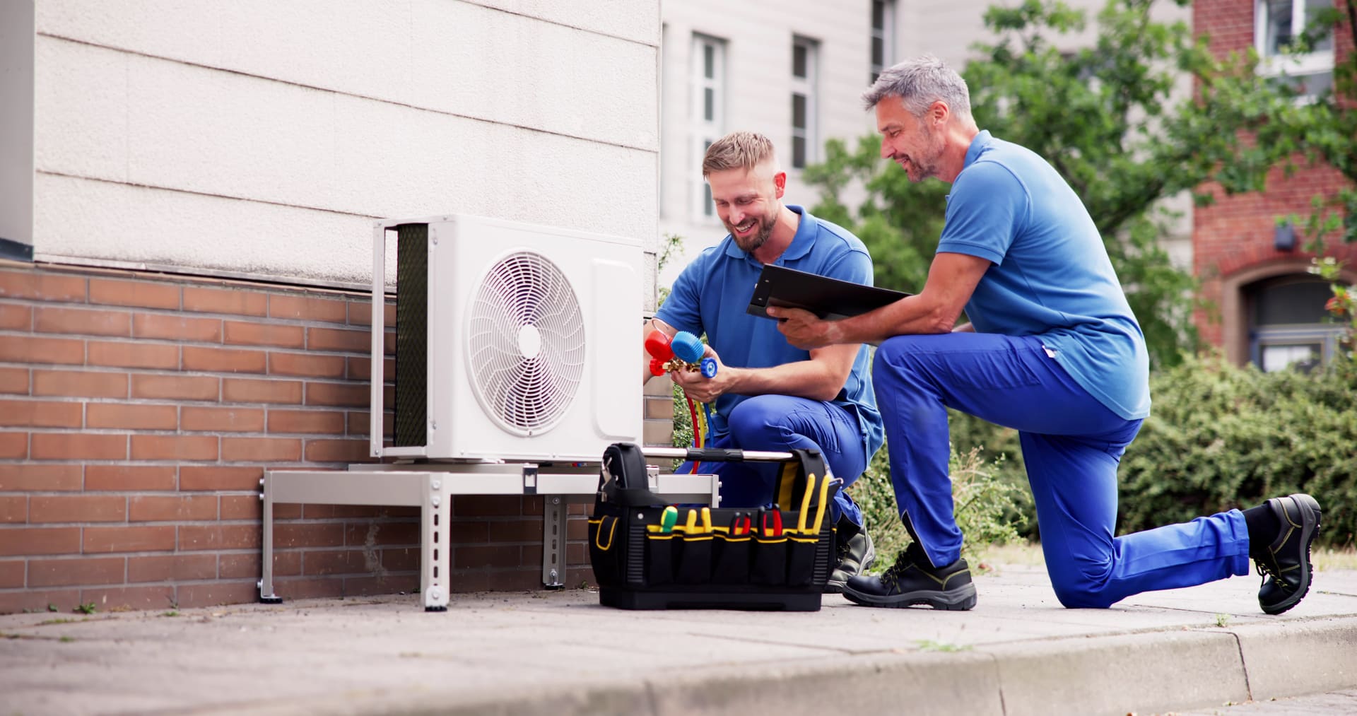 HVAC technicians testing a residential heat pump