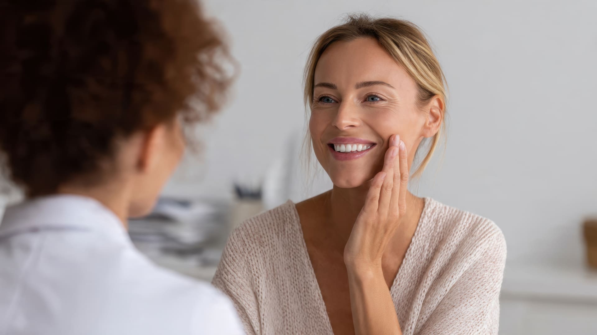 Client discussing skincare results with an aesthetics professional