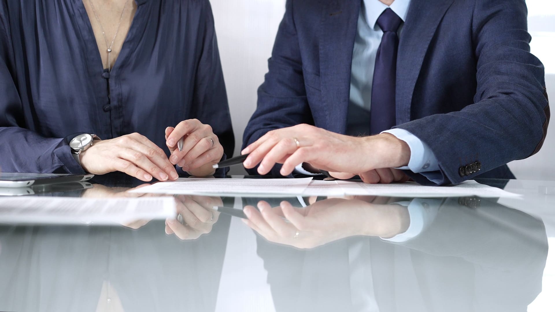 Legal and business partners reviewing a service contract